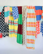 Load image into Gallery viewer, the State the Label Lattice Turkish Towel in Sunrise on a towel rack piled with multi coloured and patterned turkish towels