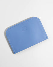 Load image into Gallery viewer, the back side of the Small Hours Leather Card Case in Sky Blue laying on an angle against a white background
