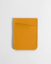 Load image into Gallery viewer, the Small Hours Slim Leather Card Holder in Yellow laying flat on a white background