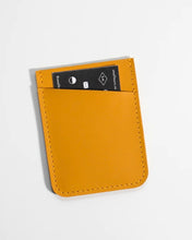 Load image into Gallery viewer, Small Hours Slim Leather Card Holder in Yellow laying flat on an angle on a white background