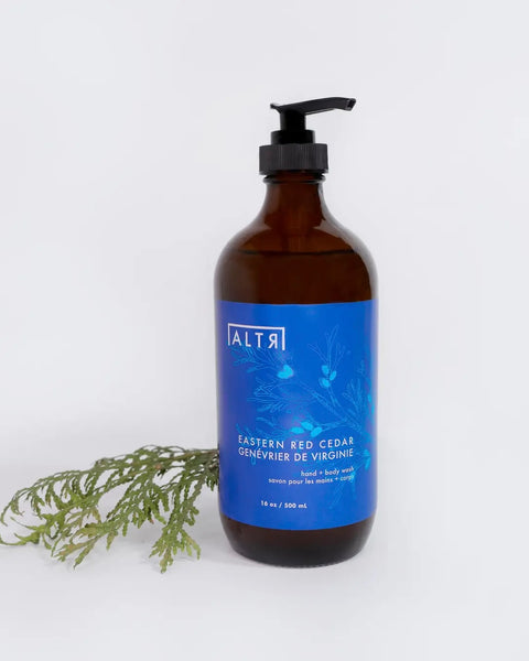the ALTR Hand & Body Wash in Eastern Red Cedar and a cedar branch sitting against a neutral background