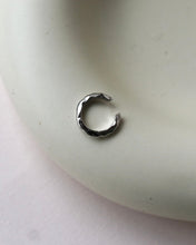 Load image into Gallery viewer, the Horace Hammered Ear Cuff in silver laying flat on a dish
