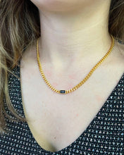 Load image into Gallery viewer, the Horace Nero Necklace worn around the neck of a model
