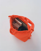 Load image into Gallery viewer, the Ölend Ona Soft Bag in coral shot from above so you can see some items inside
