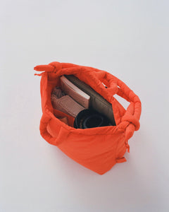 the Ölend Ona Soft Bag in coral shot from above so you can see some items inside