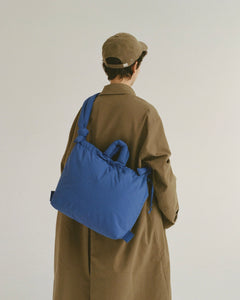 the Ölend Ona Soft Bag in cobalt blue worn crossbody by a model and shot from the back