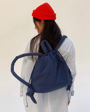 Load image into Gallery viewer, the Ölend Ona Soft Bag in navy worn by a model as a backpack shot from the back
