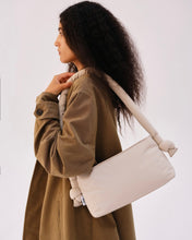 Load image into Gallery viewer, model wearing a trenchcoat holding the Ölend Taco Bag on her shoulder posing to the side

