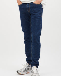 close up view of the front of the Dr. Denim Men's Clark Jean in Rubble on a model posing in front of neutral background with his hands in his pockets