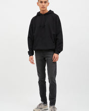 Load image into Gallery viewer, the Dr. Denim Men's Clark Jean in Cinder on a model standing in front of a neutral background staring straight into the camera