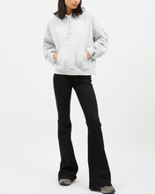 Load image into Gallery viewer, the Dr. Denim Women's Macy Jean in Black on a model posing with her hands in the pocket of her hoody