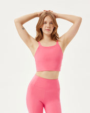 Load image into Gallery viewer, front view of the Girlfriend Collective Mia Bra in Camellia on a model posing with her hands above her head