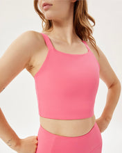 Load image into Gallery viewer, close up of the Girlfriend Collective Mia Bra in Camellia on a model posing with her hands on her hips