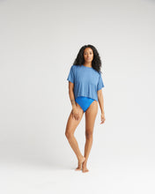 Load image into Gallery viewer, model standing wearing the Richer Poorer Women&#39;s Night Knit Tee in Blue Horizon and blue briefs posing with right knee bent and hand on thigh

