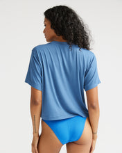 Load image into Gallery viewer, back view of model wearing the Richer Poorer Women&#39;s Night Knit Tee in Blue Horizon paired with blue briefs standing with her head looking toward her left shoulder
