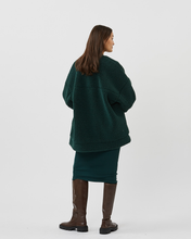 Load image into Gallery viewer, back view of a model standing in the Minimum Women&#39;s Bavory Jacket in Pine Grove and brown knee high boots
