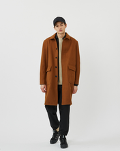 Load image into Gallery viewer, Front view of the Minimum Men's Balano Coat in Monks Robe worn open over a sweater on model
