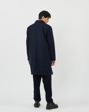 Load image into Gallery viewer, Back view of the Minimum Men's Balano Coat in Navy Blazer on a model worn with black pants and dress shoes