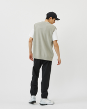 Load image into Gallery viewer, Back view of the Minimum Men&#39;s Vastar Vest in Ghost Grey worn with a white tee, black pants and white sneakers
