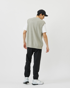 Back view of the Minimum Men's Vastar Vest in Ghost Grey worn with a white tee, black pants and white sneakers