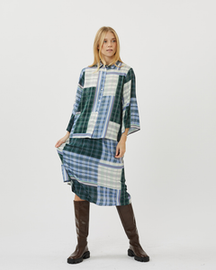 model standing facing the camera wearing the Minimum Women's Nilana Blouse in Impression with the matching plaid skirt and knee high boots
