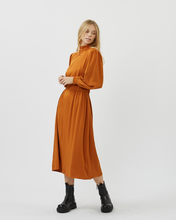 Load image into Gallery viewer, front view of the Minimum Women&#39;s Larada Midi Dress in Roasted Pecan worn by a model styled with black boots
