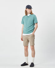 Load image into Gallery viewer, the Minimum Men's Cavli Polo in Oil Blue on a model posing with his hand in his pocket