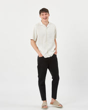Load image into Gallery viewer, model posing with his hands in his pockets wearing the Minimum Men's Jole Shirt in White Asparagus