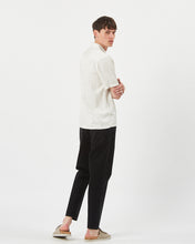 Load image into Gallery viewer, back view of the Minimum Men's Jole Shirt in White Asparagus on a model posing looking over his shoulder