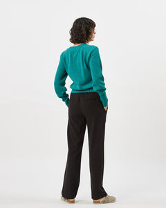 back view of the Minimum Women's Cardine Cardigan in Bayou on a model