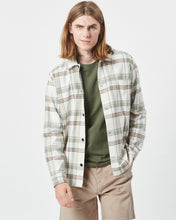 Load image into Gallery viewer, Minimum Men&#39;s Kaase Overshirt in Oil Blue on a model posing with one hand in his pocket looking at the camera with a smirk
