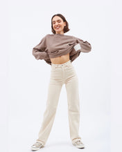 Load image into Gallery viewer, Dr. Denim Women&#39;s Moxy Jean in Loom State on a model posing holding her sweatshirt up above her waist
