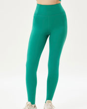 Load image into Gallery viewer, close up of the front of a model wearing green leggings

