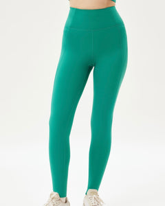 close up of the front of a model wearing green leggings