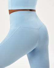 Load image into Gallery viewer, close up back view of the Girlfriend Collective High-Rise Crop Legging in Cerulean