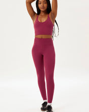 Load image into Gallery viewer, model posing with her hangs above her head wearing the Girlfriend Collective Ultralight Legging in Rhododendron