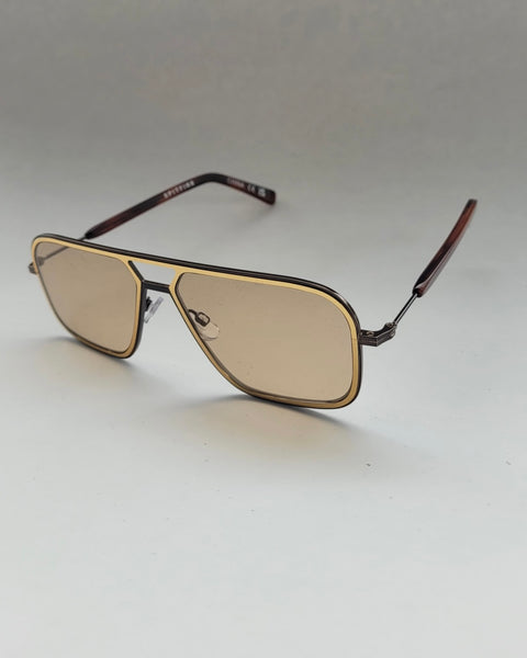 the Spitfire Congelton Sunglasses in gold and tan sitting on an angle against a neutral background