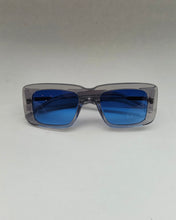 Load image into Gallery viewer, the Spitfire Cut Seventy Sunglasses in clear with blue lens laying on a neutral background
