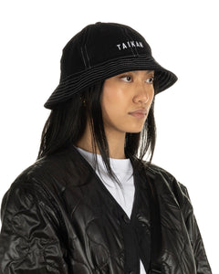 the Taikan Bell Bucket Hat in Black Contrast on a model photographed at an angle