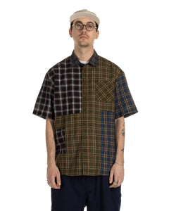the Taikan Patchwork Shirt in Olive Plaid on a model looking straight into the camera