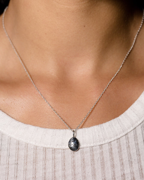 close up of the Hunt of Hounds Billie Necklace in Silver worn around neck with white tee