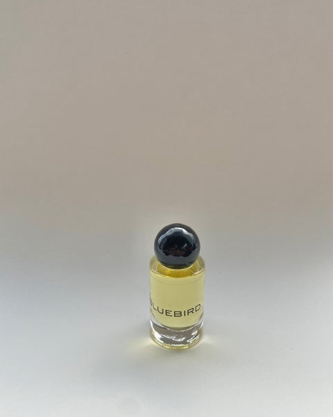 Olivine Atelier Bluebird Perfume Oil in glass bottle against neutral background