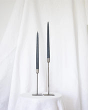 Load image into Gallery viewer, a pair of Socco Designs Taper Candles in charcoal in two tapers of varying heights against a white sheet background