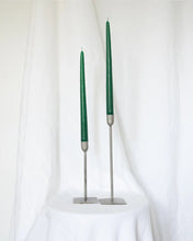 Load image into Gallery viewer, a pair of Socco Designs Taper Candles in green in two tapers of varying heights against a white sheet background