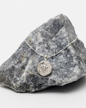 Load image into Gallery viewer, Hunt of Hounds Without End Necklace in Silver draped over a rock
