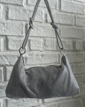 Load image into Gallery viewer, the Slouchy Crystal Shoulder Bag in Silver hanging in front of a white brick background

