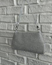 Load image into Gallery viewer, the Crystal Clutch Bag in Silver hanging against a white brick background
