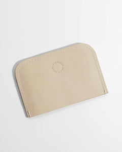 the back side of the Small Hours Leather Card Case in Almond laying flat on a white background