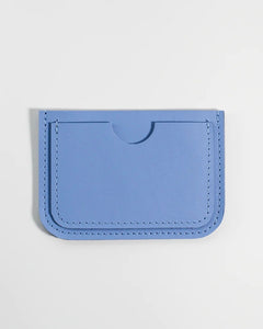 the Small Hours Leather Card Case in Sky Blue laying flat on a white background