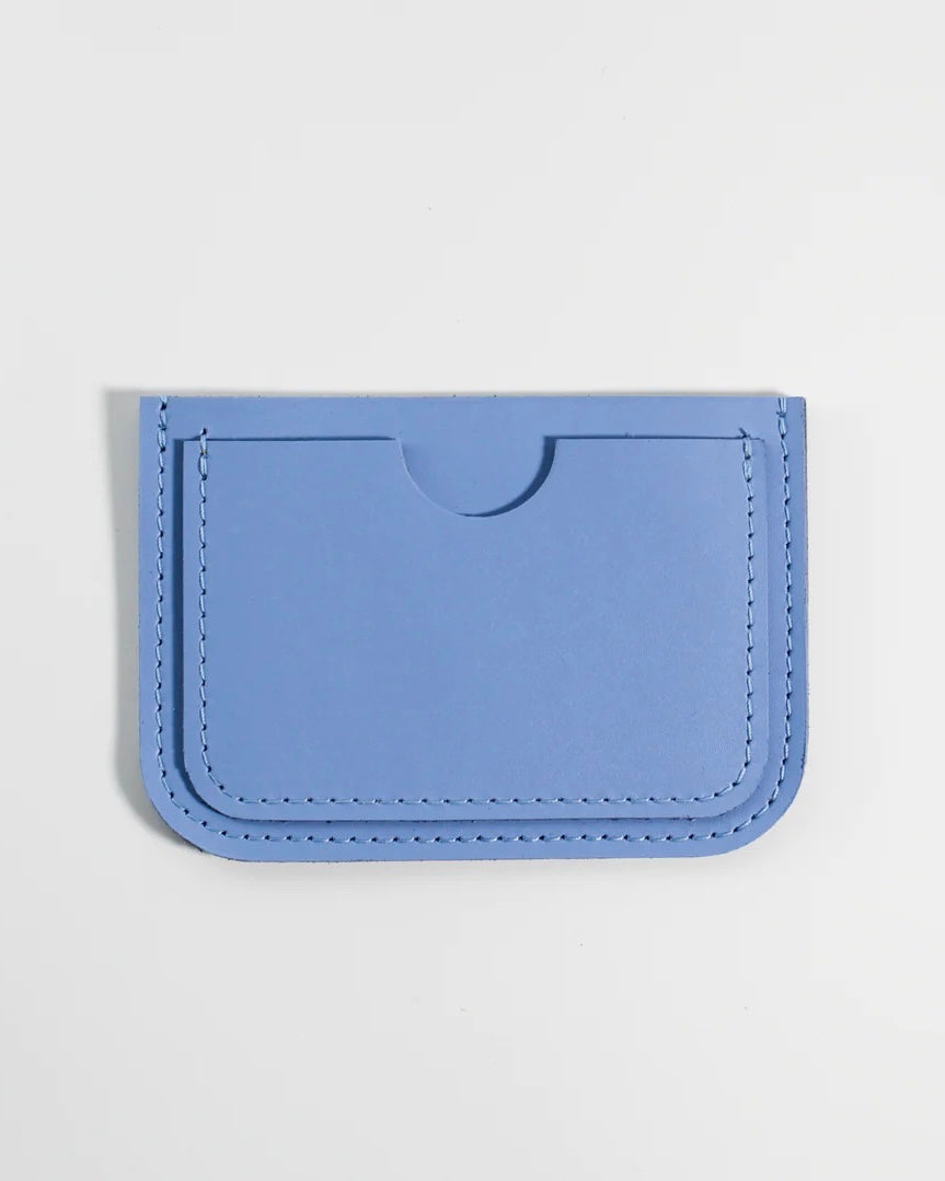 the Small Hours Leather Card Case in Sky Blue laying flat on a white background